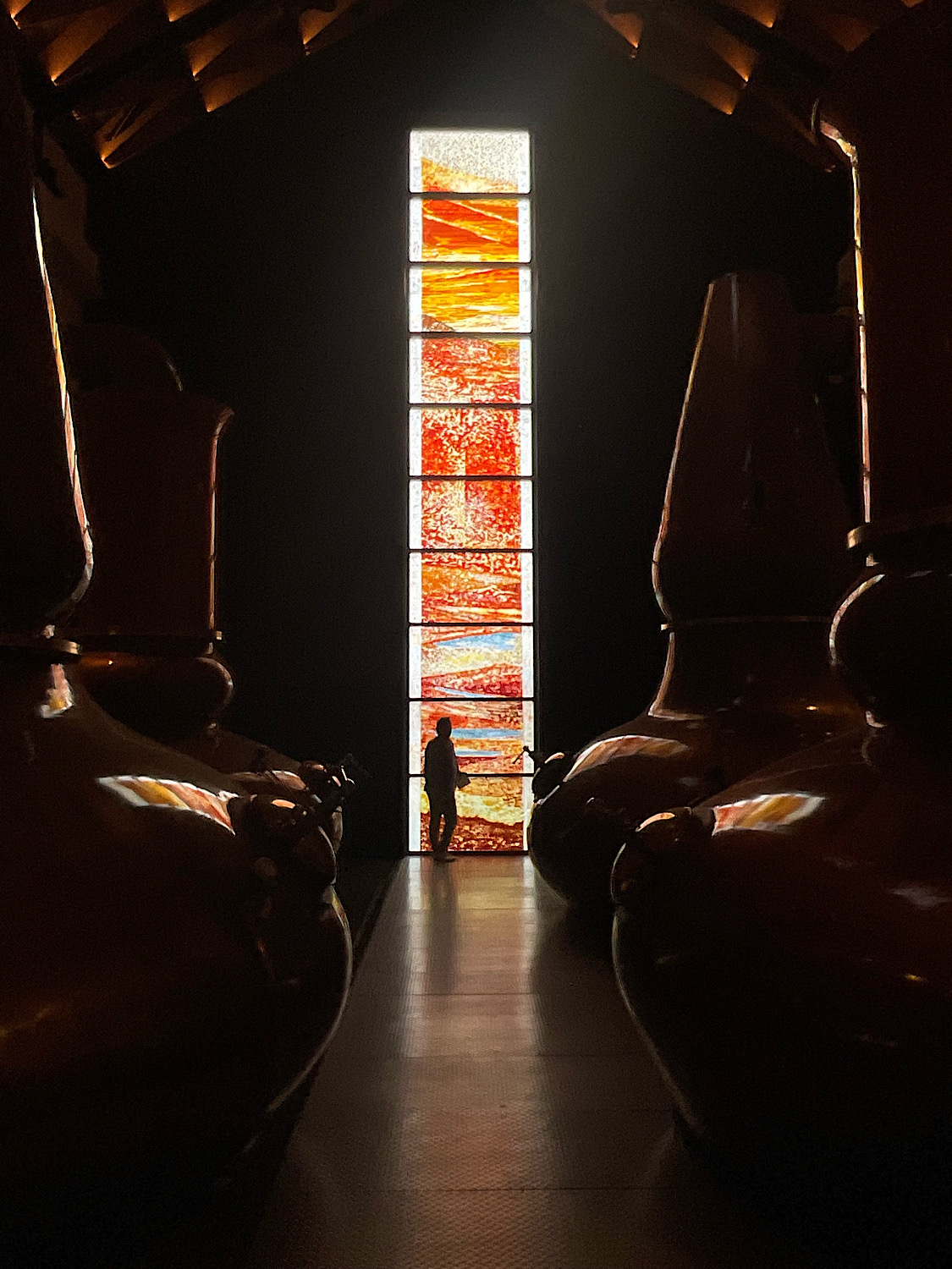 John Kenneth Clark standing in front of the 10-metre Dalmore Still House Window