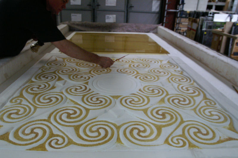 Panel in the kiln, frit being applied to the form