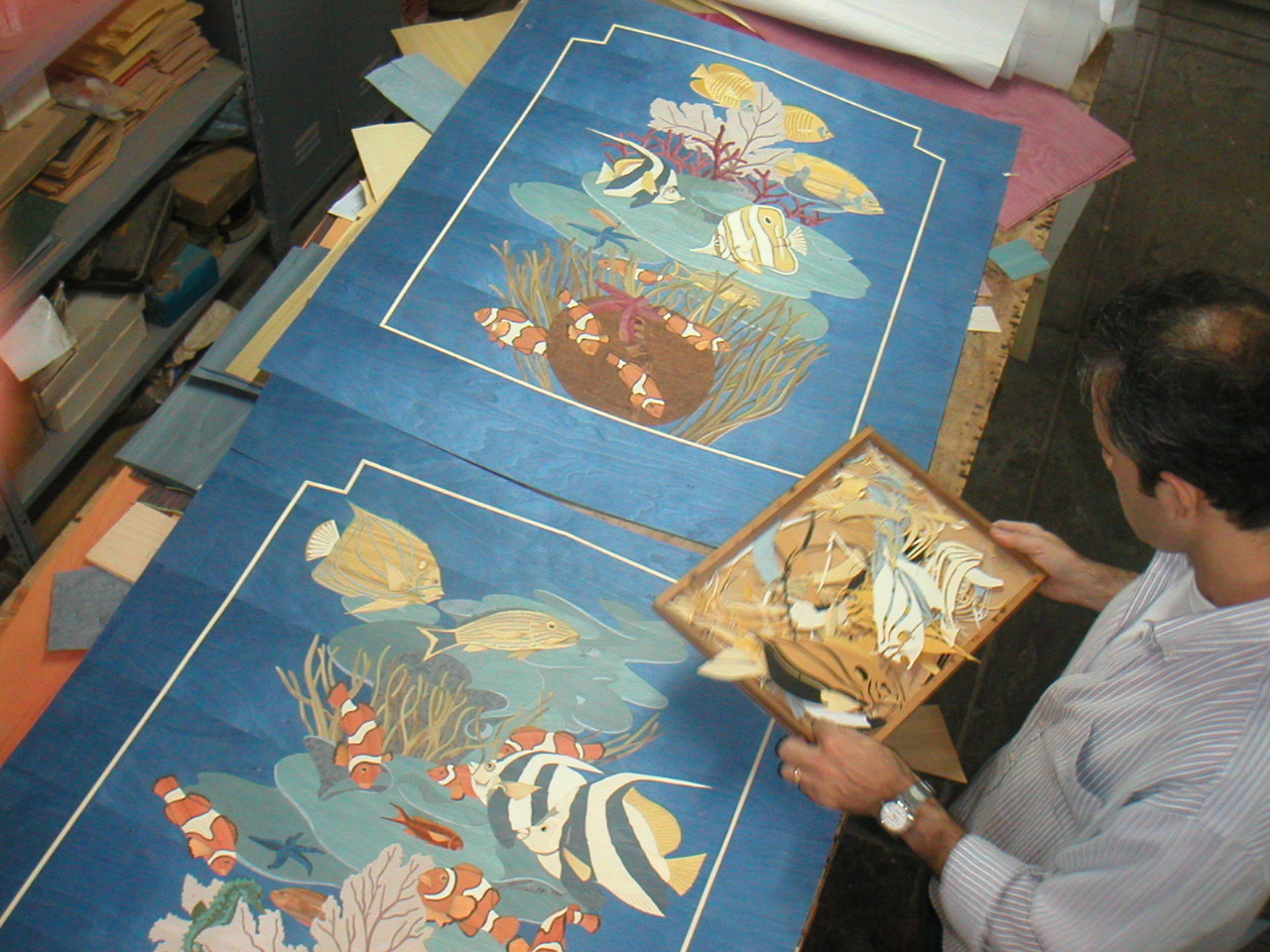 The client reviewing a completed panel in Sorrento alongside the original drawing