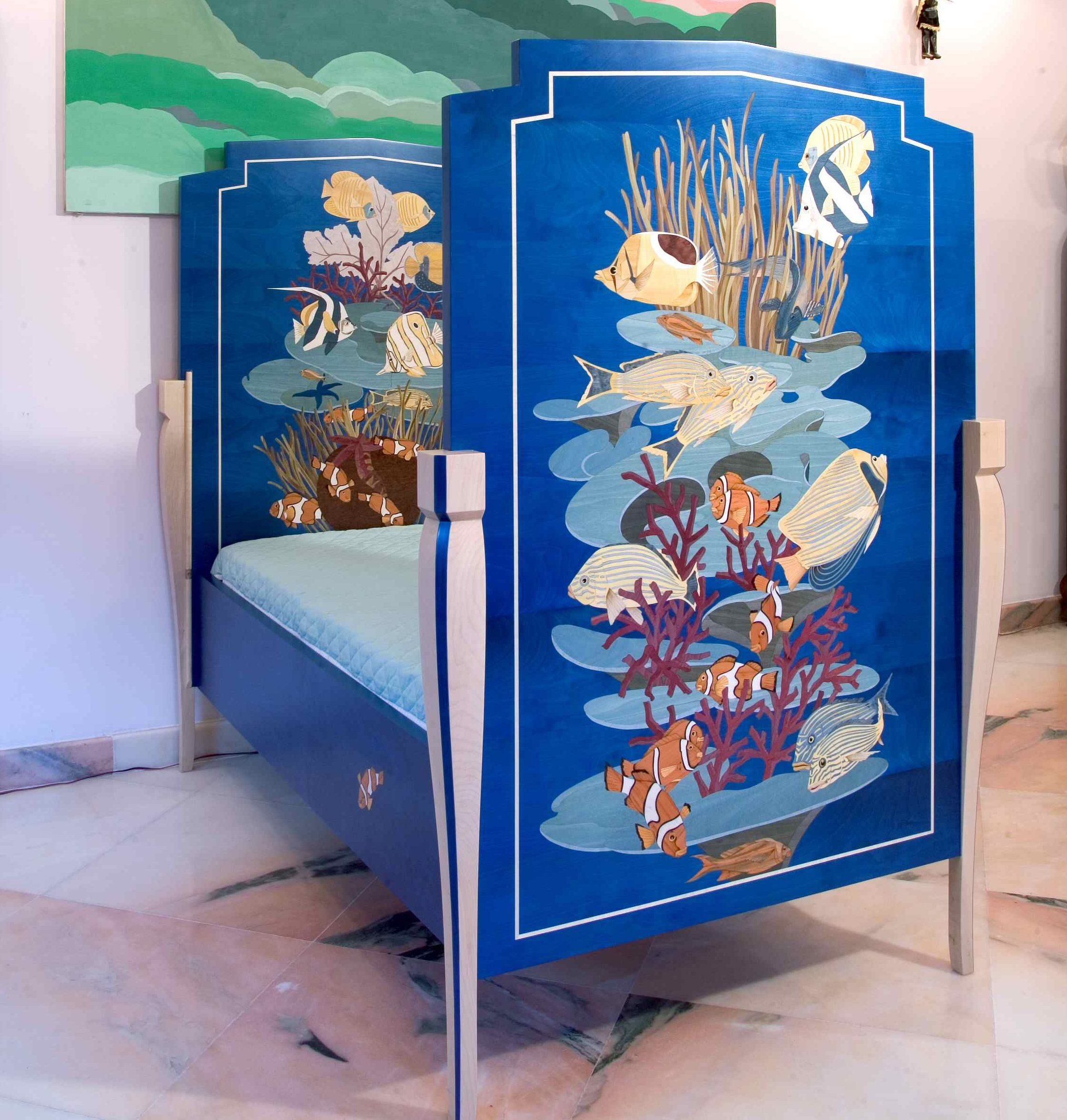 The cobalt blue bed — dyed wood veneers, deep ocean world, designed to convert to a sofa