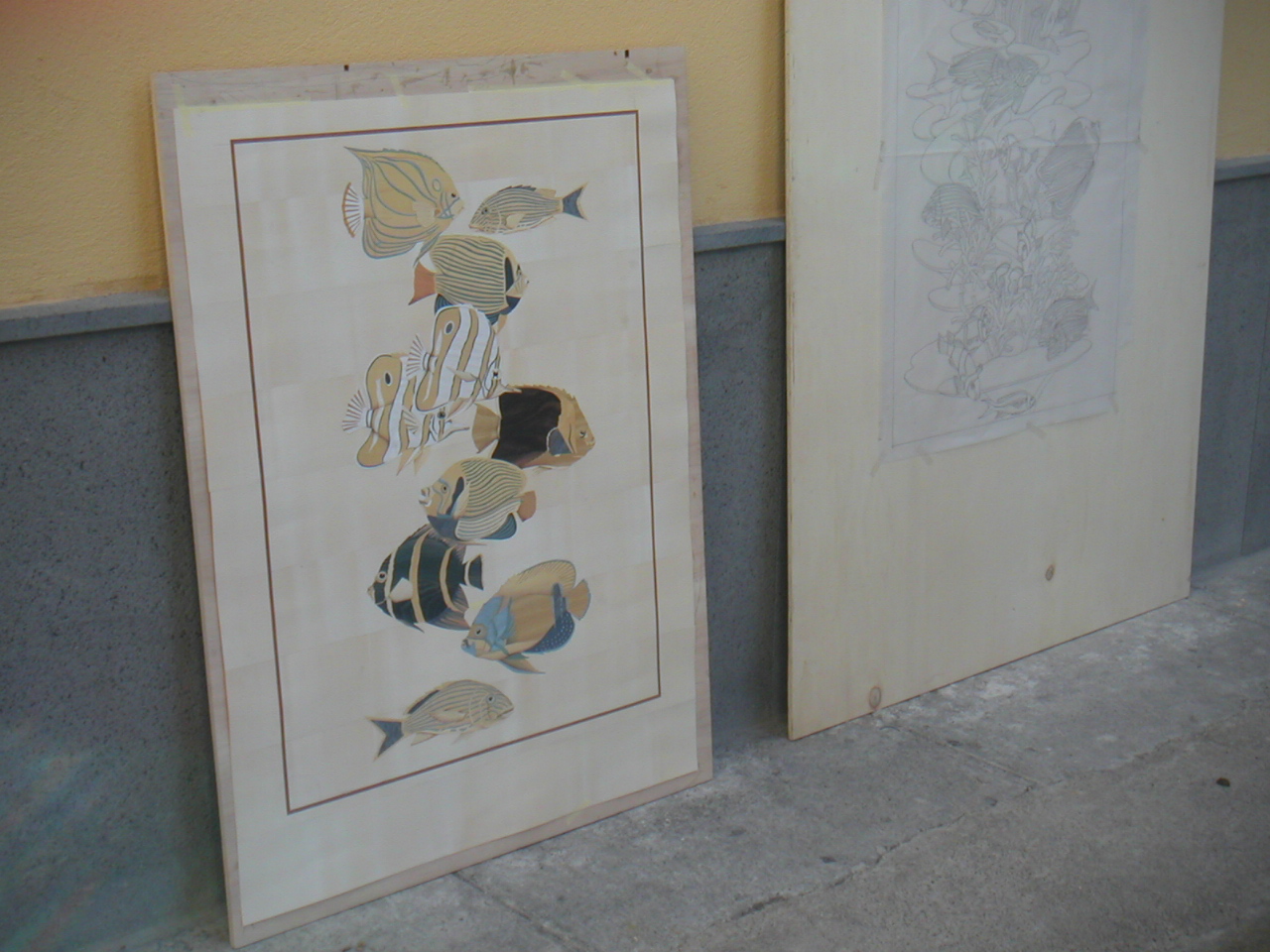 The client reviewing a completed panel in Sorrento alongside the original drawing
